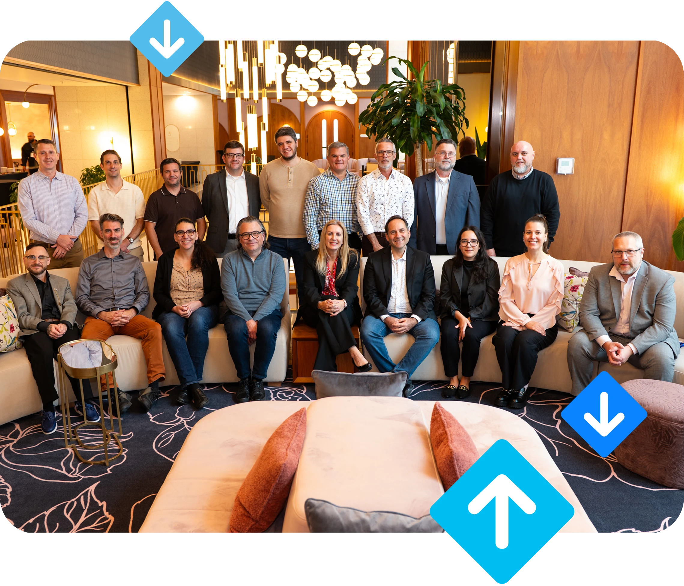 Group photo of Dispatch Science team members and customers at the inaugural User Conference in Montreal, seated on a curved sofa and standing behind it in a modern hotel lounge